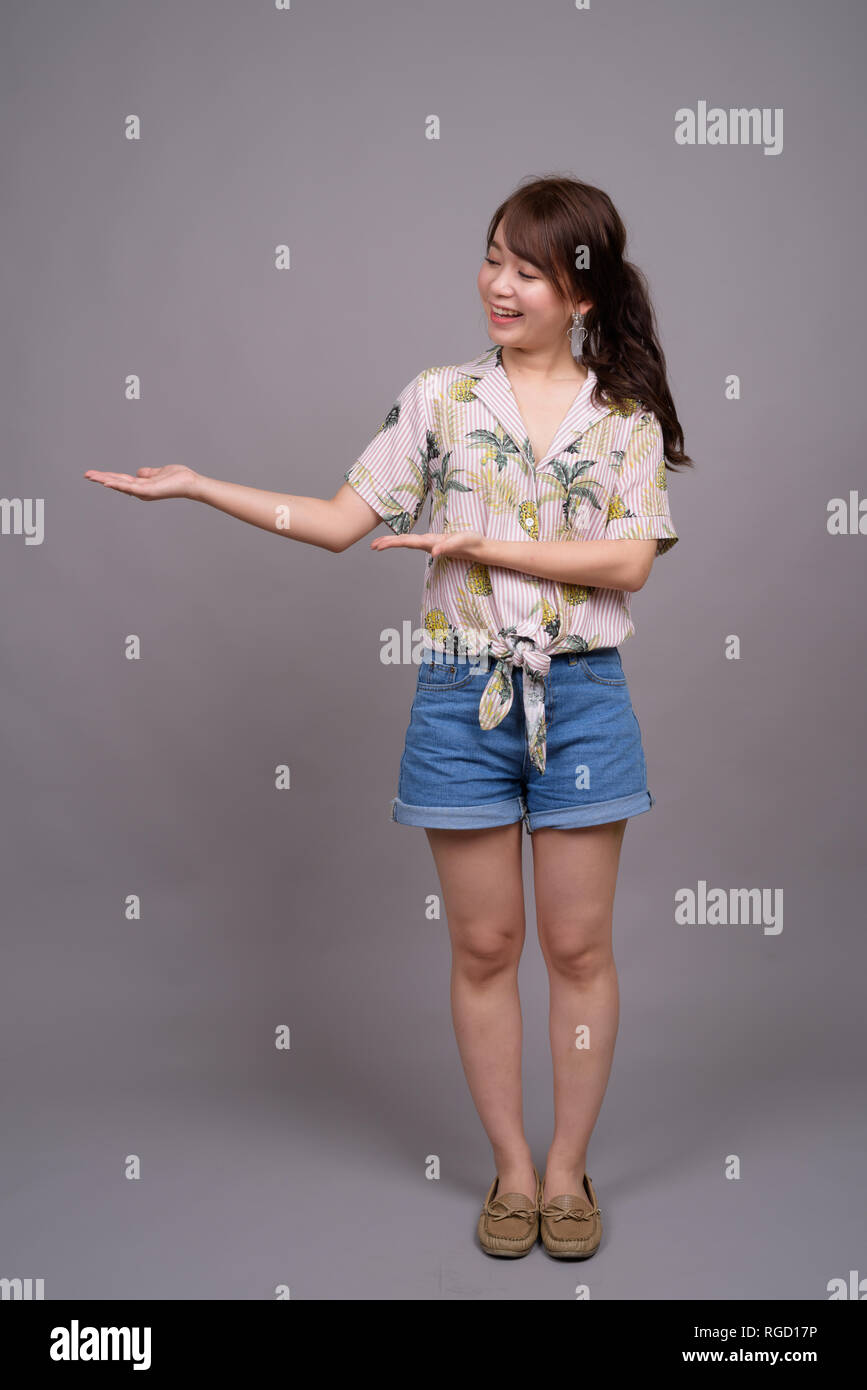 Full length portrait of beautiful young Asian woman standing Stock ...