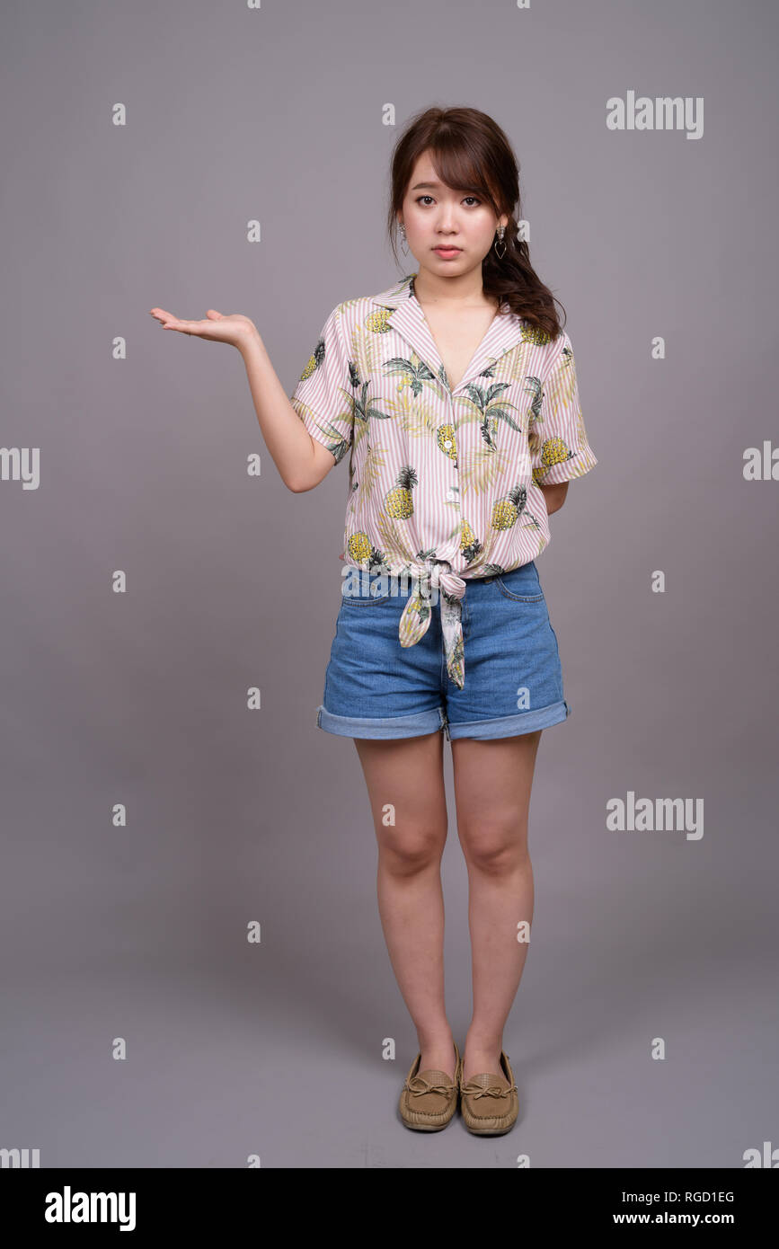 Full length portrait of beautiful young Asian woman standing Stock ...