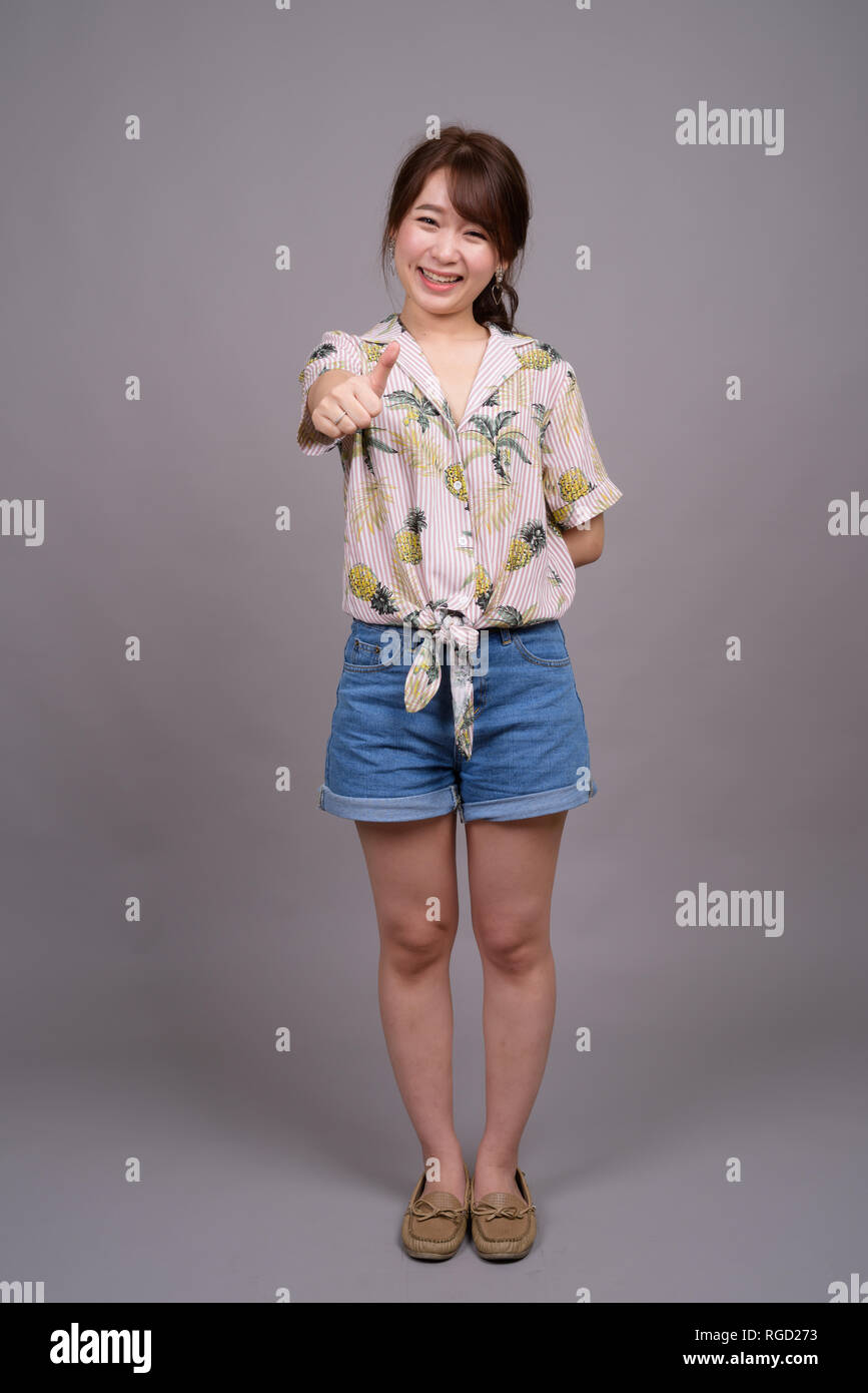 Full length portrait of beautiful young Asian woman standing Stock ...