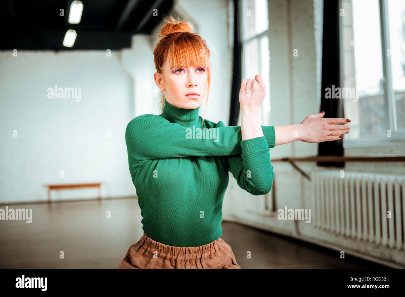 Sportive woman stretching arm hi-res stock photography and images - Alamy