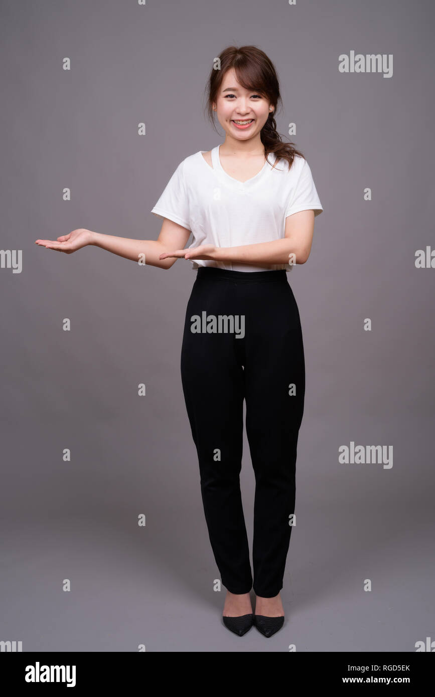 Full length shot of young Asian woman standing Stock Photo - Alamy