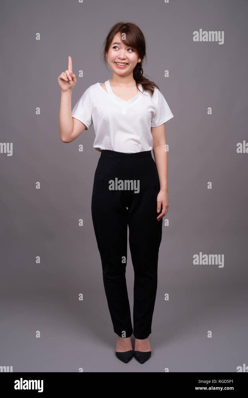 Full length shot of young Asian woman standing Stock Photo - Alamy