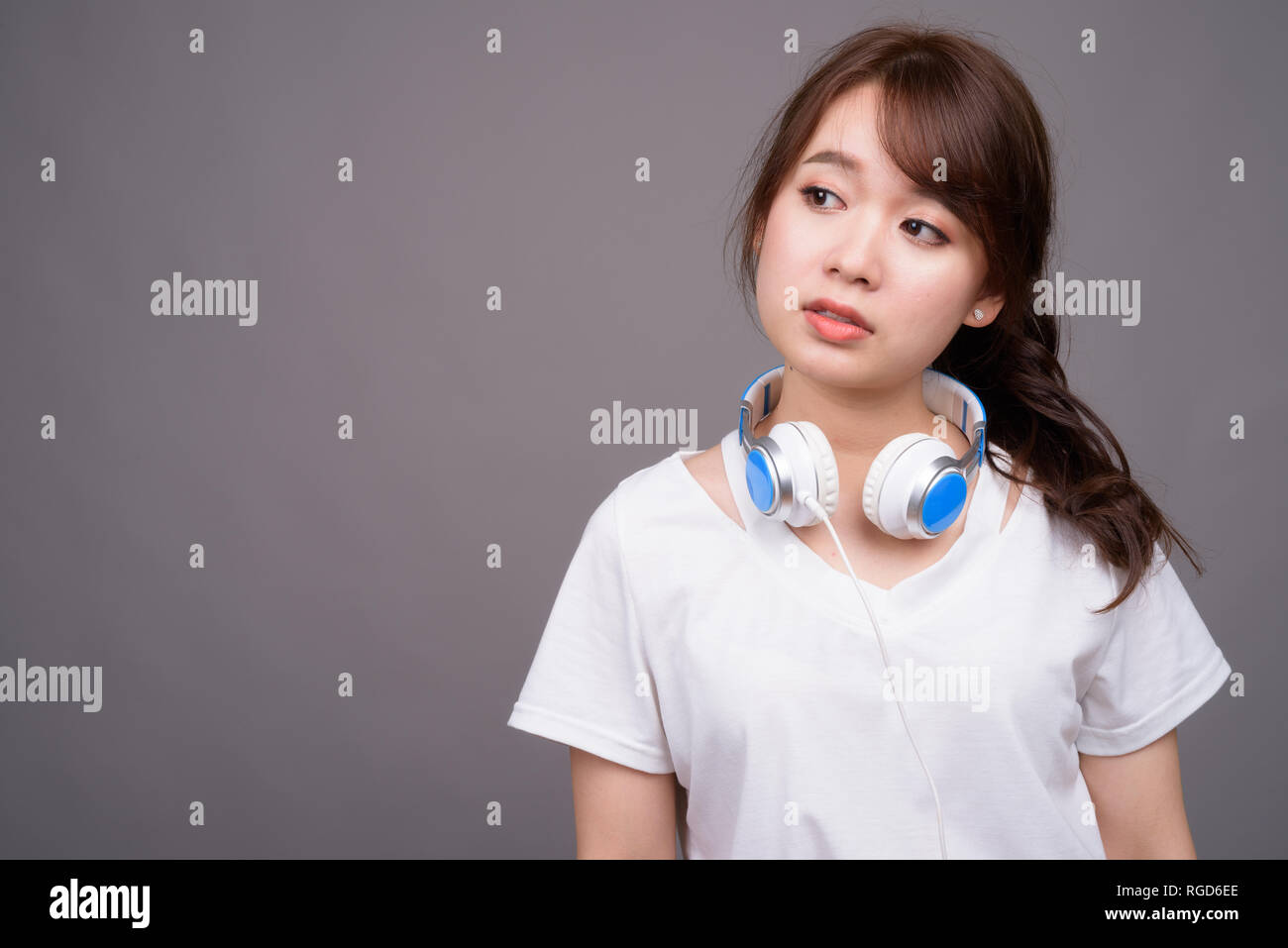 Young beautiful Asian woman wearing headphones for music Stock Photo ...