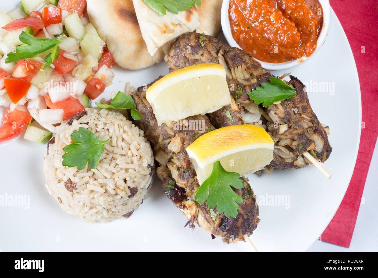 A Turkish dish of Lamb Sis Kebap, with fragrant rice, side salad and flatbread Stock Photo