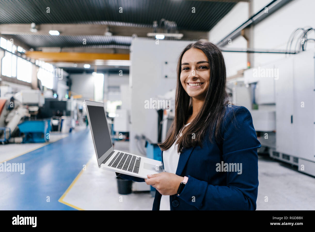 Confident Woman Working In High Tech Enterprise Holding Laptop Stock Photo Alamy
