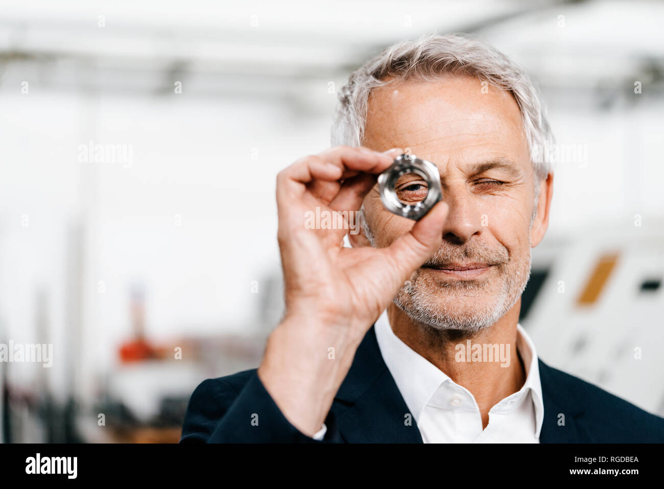 Manager in high tech enterprise, checking machine parts Stock Photo