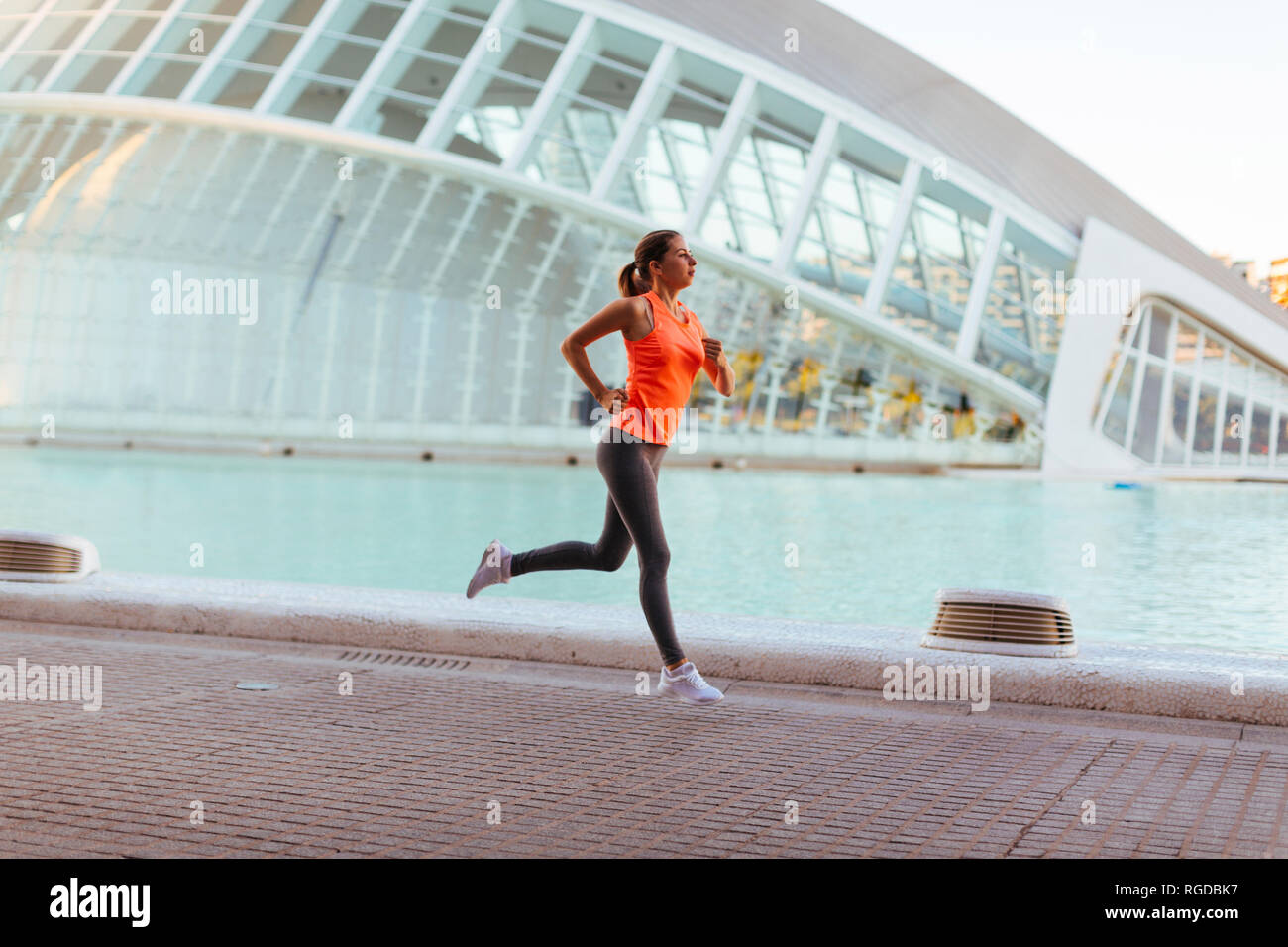 Spain, Valencia, woman running at Ciudad de las Artes y de Las Ciencias Stock Photo