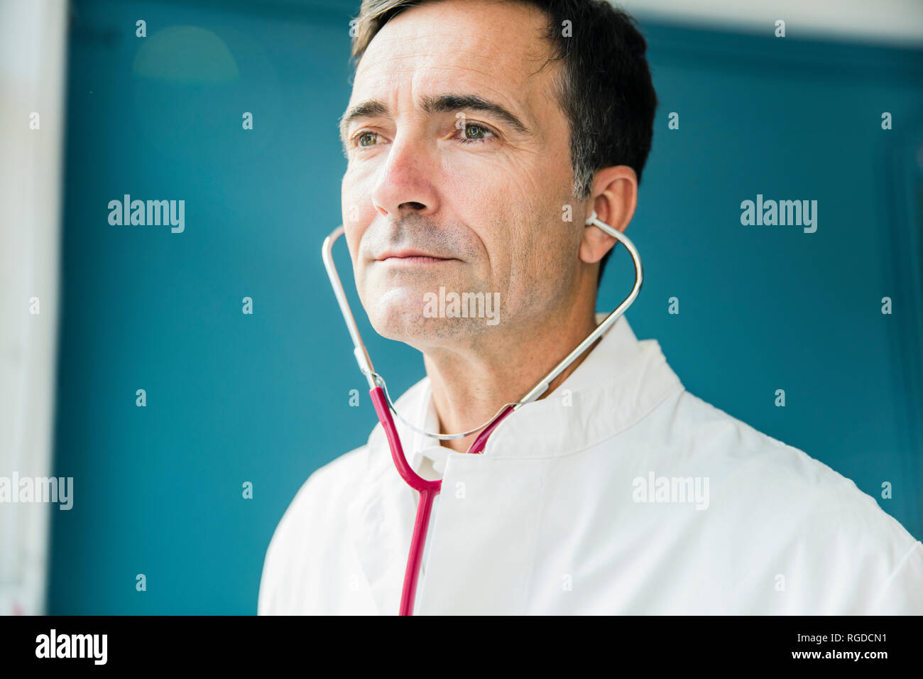 Portrait of doctor with stethoscope looking sideways Stock Photo