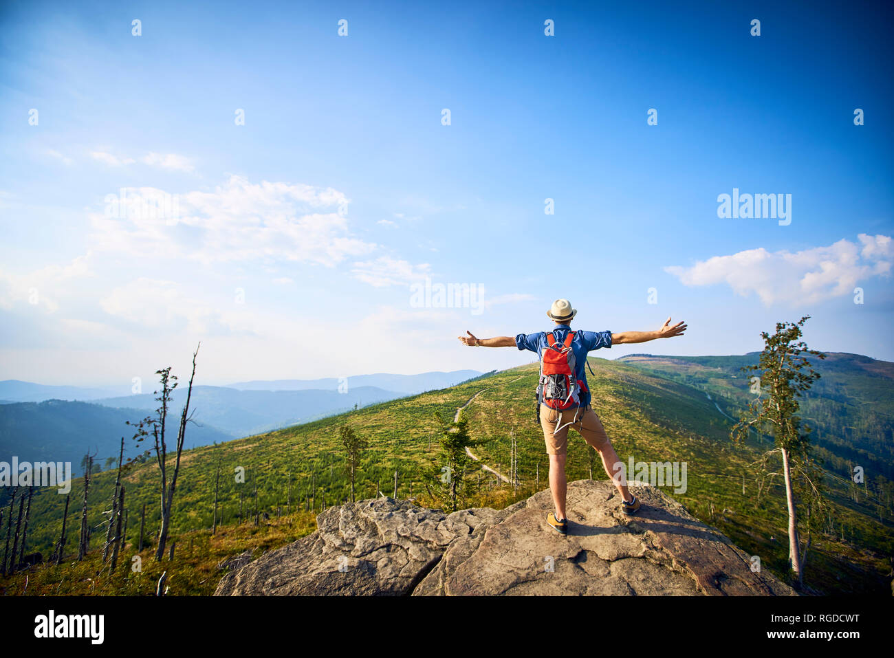 Rear view of hiker in mountains enjoying the view Stock Photo