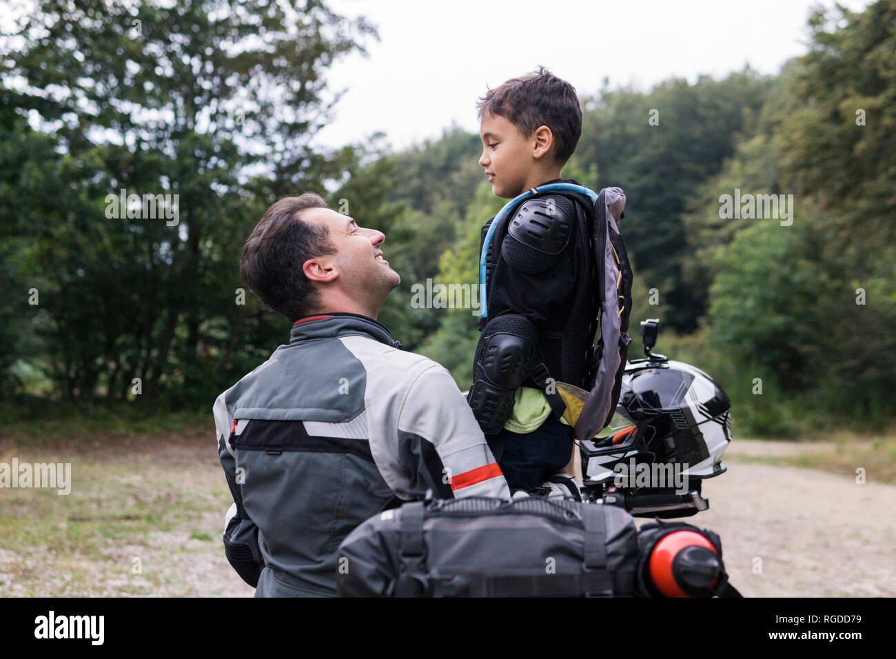 Father and son having a break during a motorbike trip Stock Photo