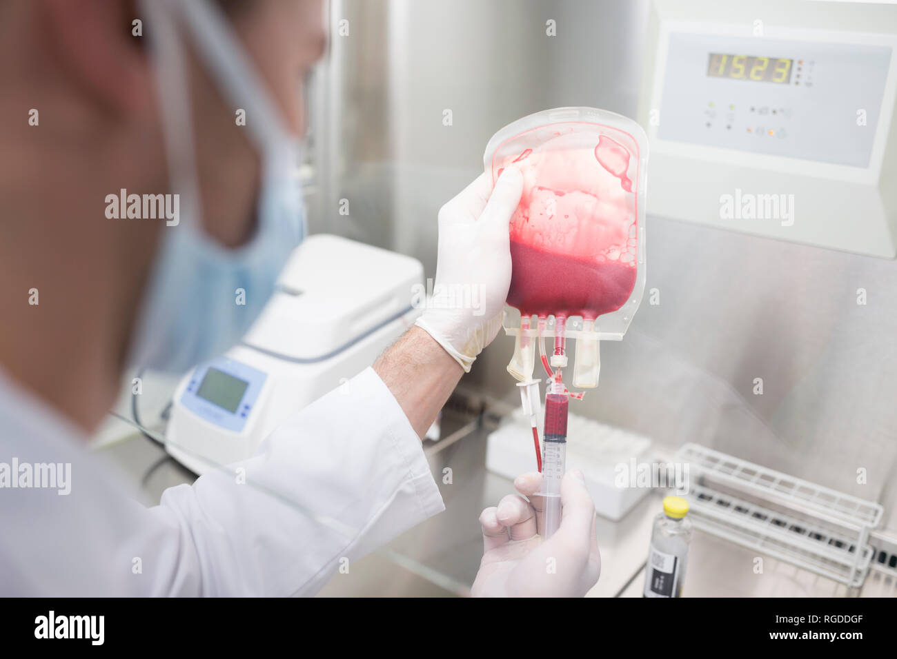 Scientist working with blood bag in lab Stock Photo