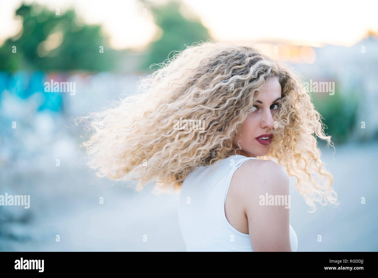 Blond young woman with curly hair Stock Photo