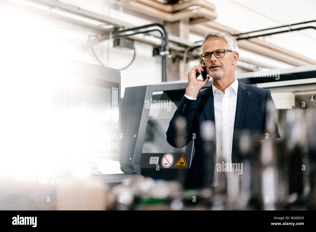 Manager talking on the phone in high tech company Stock Photo