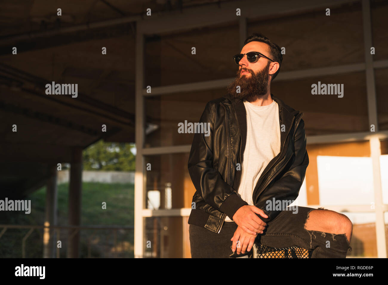 Stylish bearded young man outdoors looking sideways Stock Photo