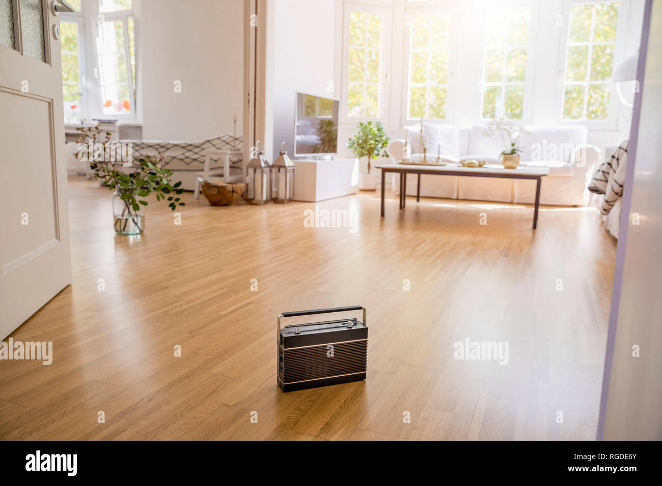 Transistor radio standing on parquet in a modern living room Stock Photo