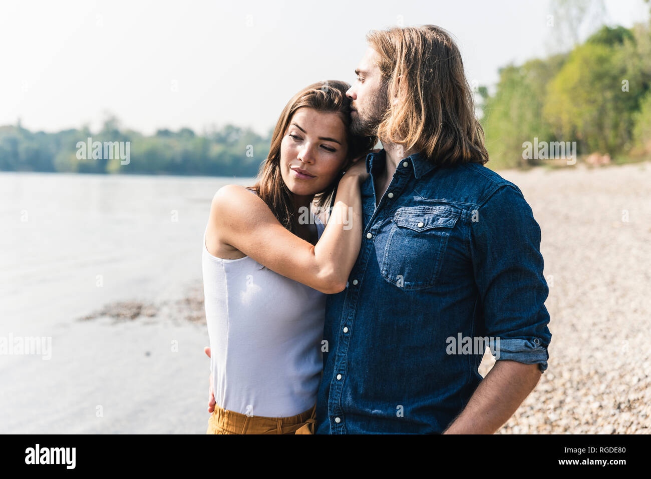 Young couple in love at the riverside Stock Photo