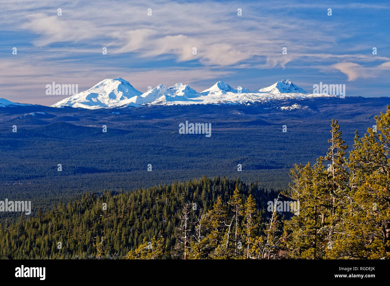 41,987.07188 South Middle North Sisters & Broken Top Mts, distant snowy Cascade Mountains (3 Three Sisters), pines conifer trees forest landscape Stock Photo
