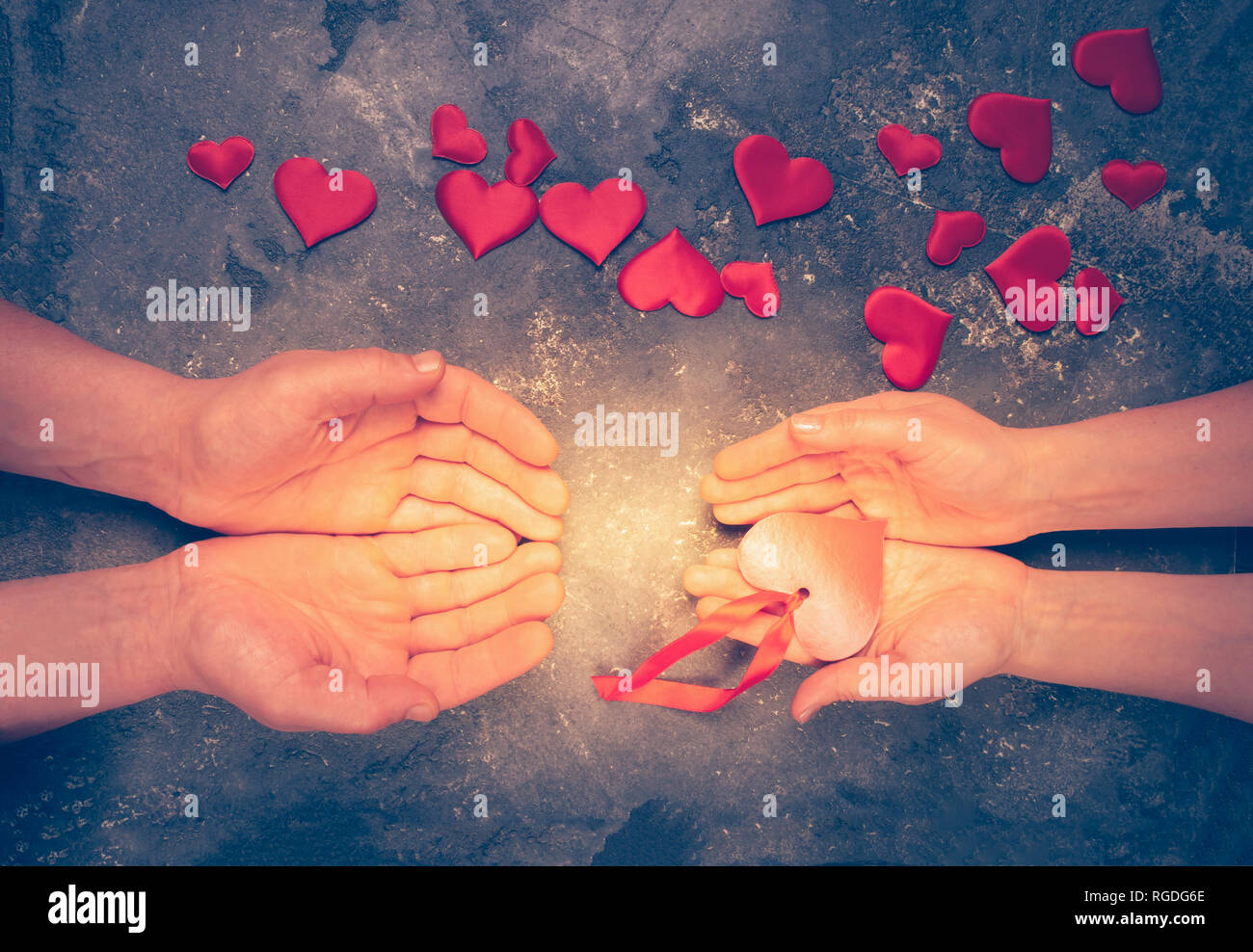 The symbol of love is the heart in female and male hands. The concept of love and kindness. Flat