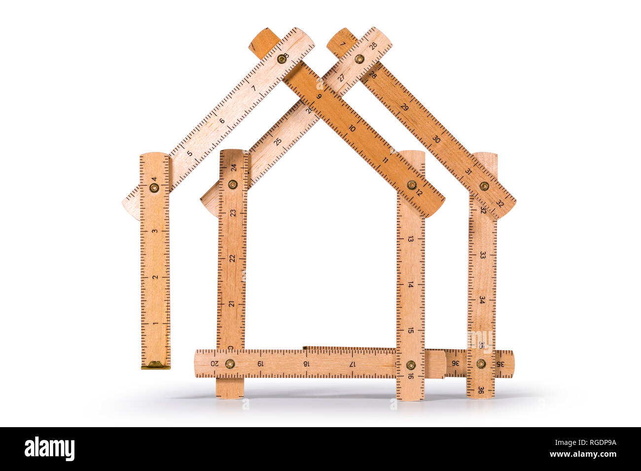 Wooden folding inch ruler in the shape of two houses. Isolated on white background. Clipping path included. Stock Photo