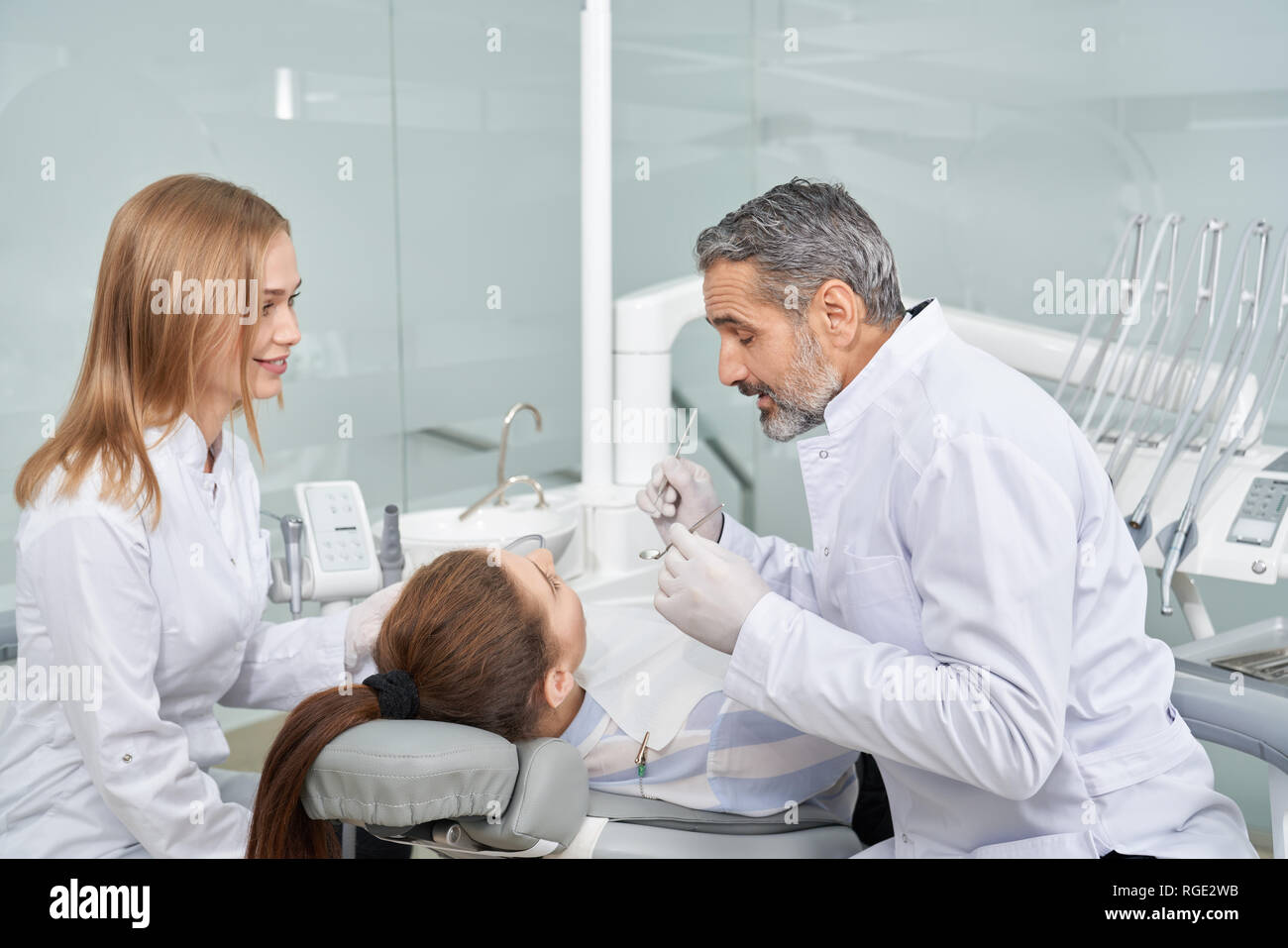 Stomatology doctor working with client in dentist Young woman