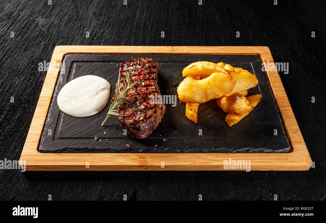 Sirloin steak with golden potatoes and gorgonzola sauce Stock Photo