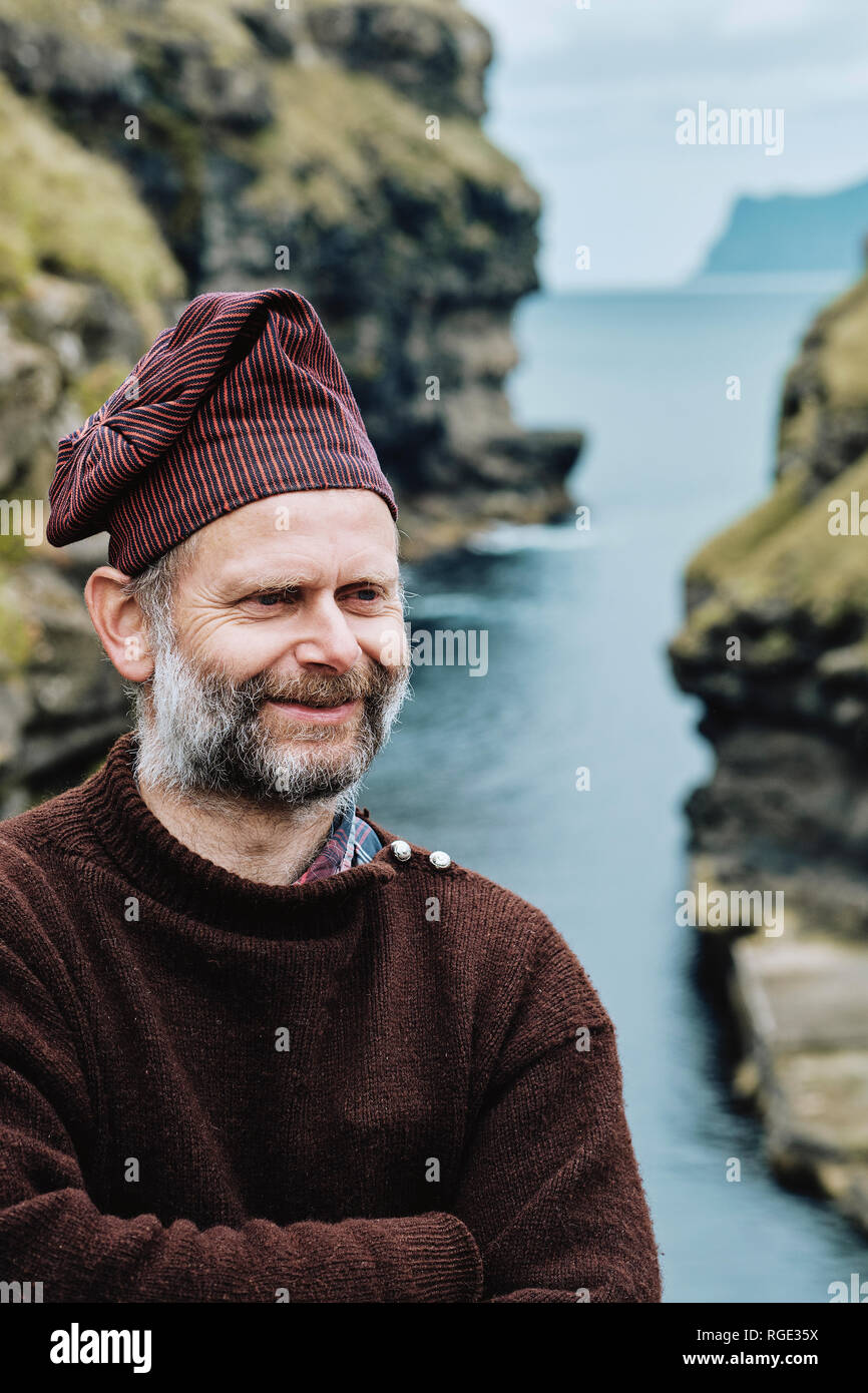 A Faroe islander wearing a traditional Faroese wool sweater and hat in Gjogv Esturoy in the Faroe Islands. Stock Photo