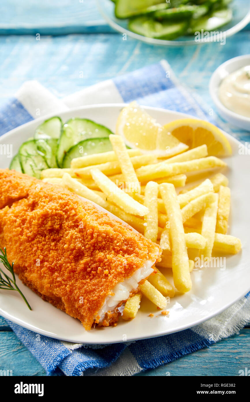 Crispy deep fried fillet of codfish with breadcrumbs served with French