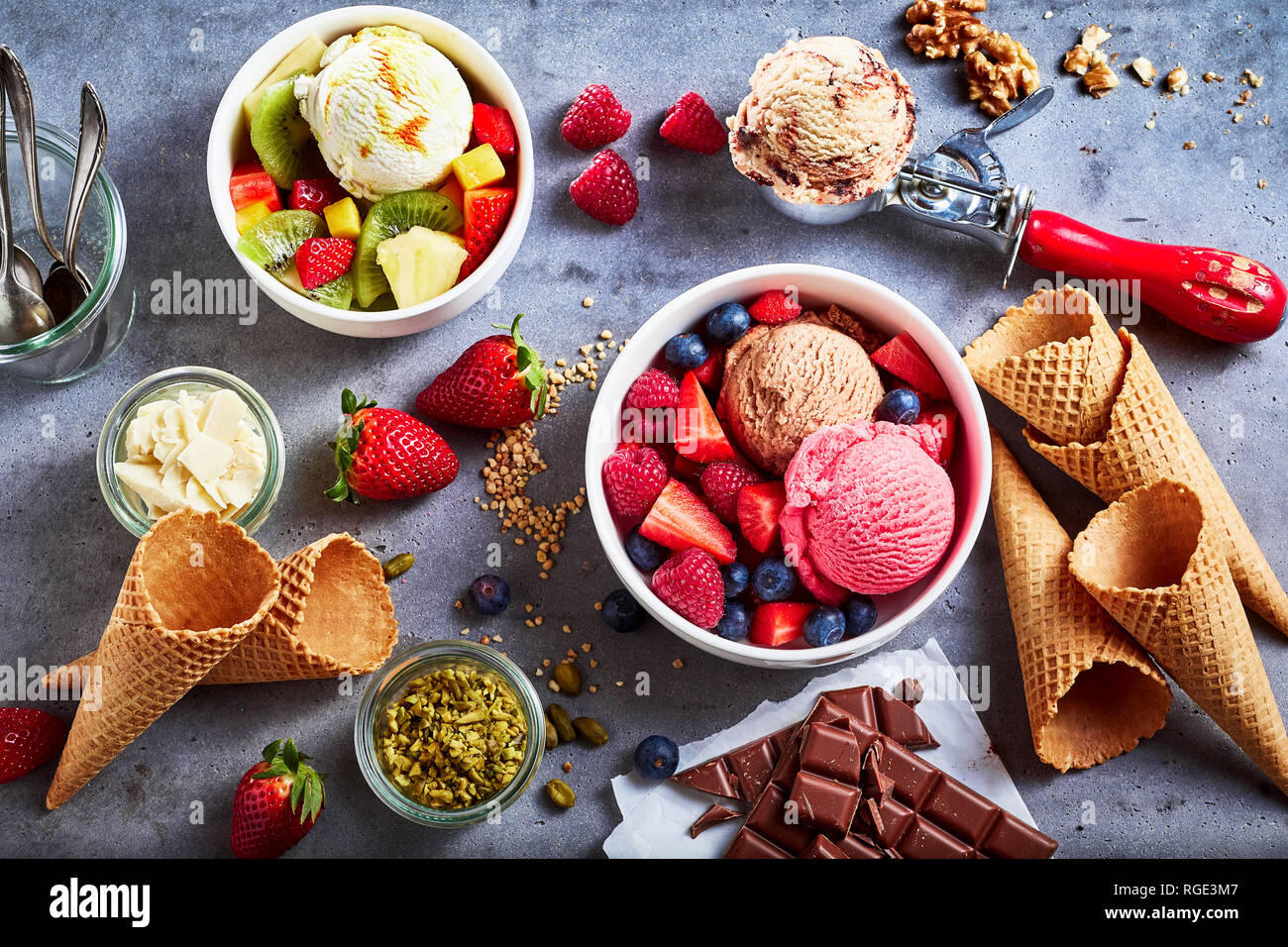 https://c8.alamy.com/comp/RGE3M7/fresh-fruit-with-scoops-of-creamy-speciality-ice-cream-in-assorted-flavors-with-raspberry-berry-blueberry-strawberry-walnut-pistachio-chocolate-RGE3M7.jpg