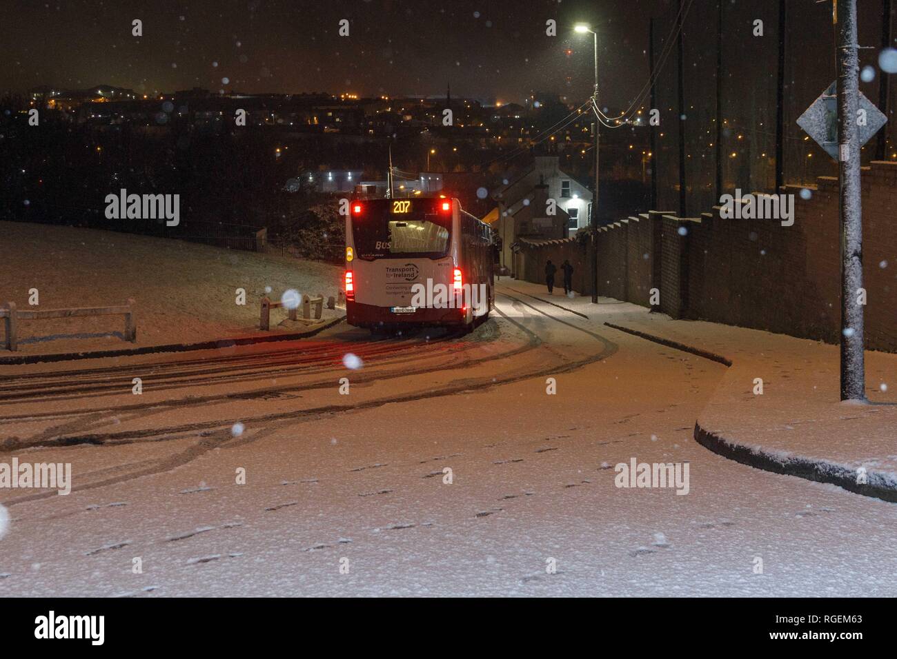 Cork, Ireland, 29th January, 2019.   Snow in Ballyvolane, Cork City. Today a Yellow Weather Warning was put in place accross the country by MET Eireann for ice and snow. Heavy snowfall hit parts of Cork City and County throughout the day making some roads treacherous and driving particulary dangerous throughout the city. Pictured here is the 207 bus making its way down Ballincollie Road. Credit: Damian Coleman/ Alamy Live News. Stock Photo