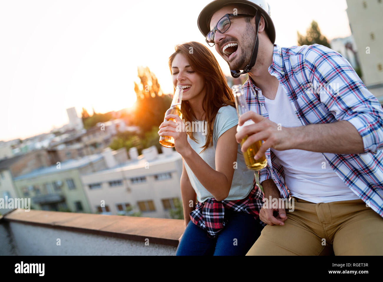 Happy couple enjoying drinks and balcony Stock Photo