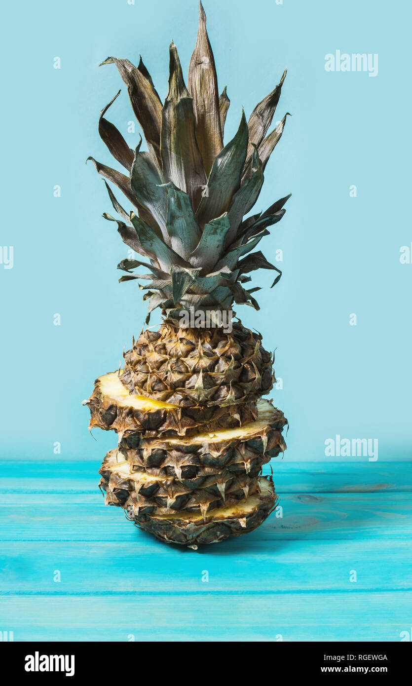Sliced pineapple fruit on a blue background. Stock Photo