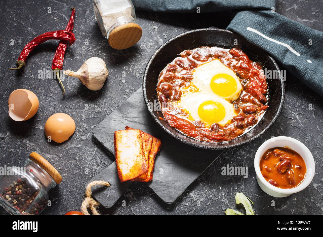 Shakshuka, Fried Eggs in Tomato Sauce in iron frying pan. Typical