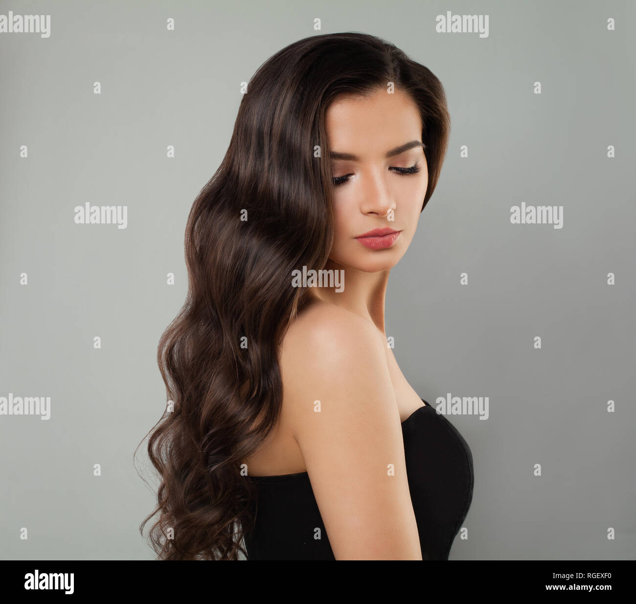 Young brunette model portrait. Perfect woman with long wavy hairstyle Stock Photo