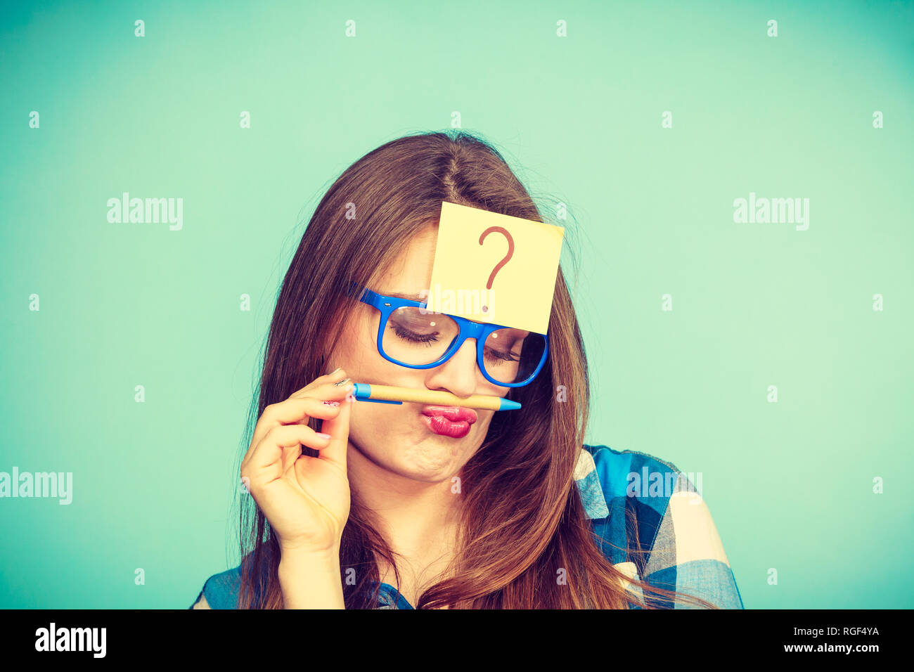 Thinking woman with big nerdy eyeglasses and question mark on forehead ...
