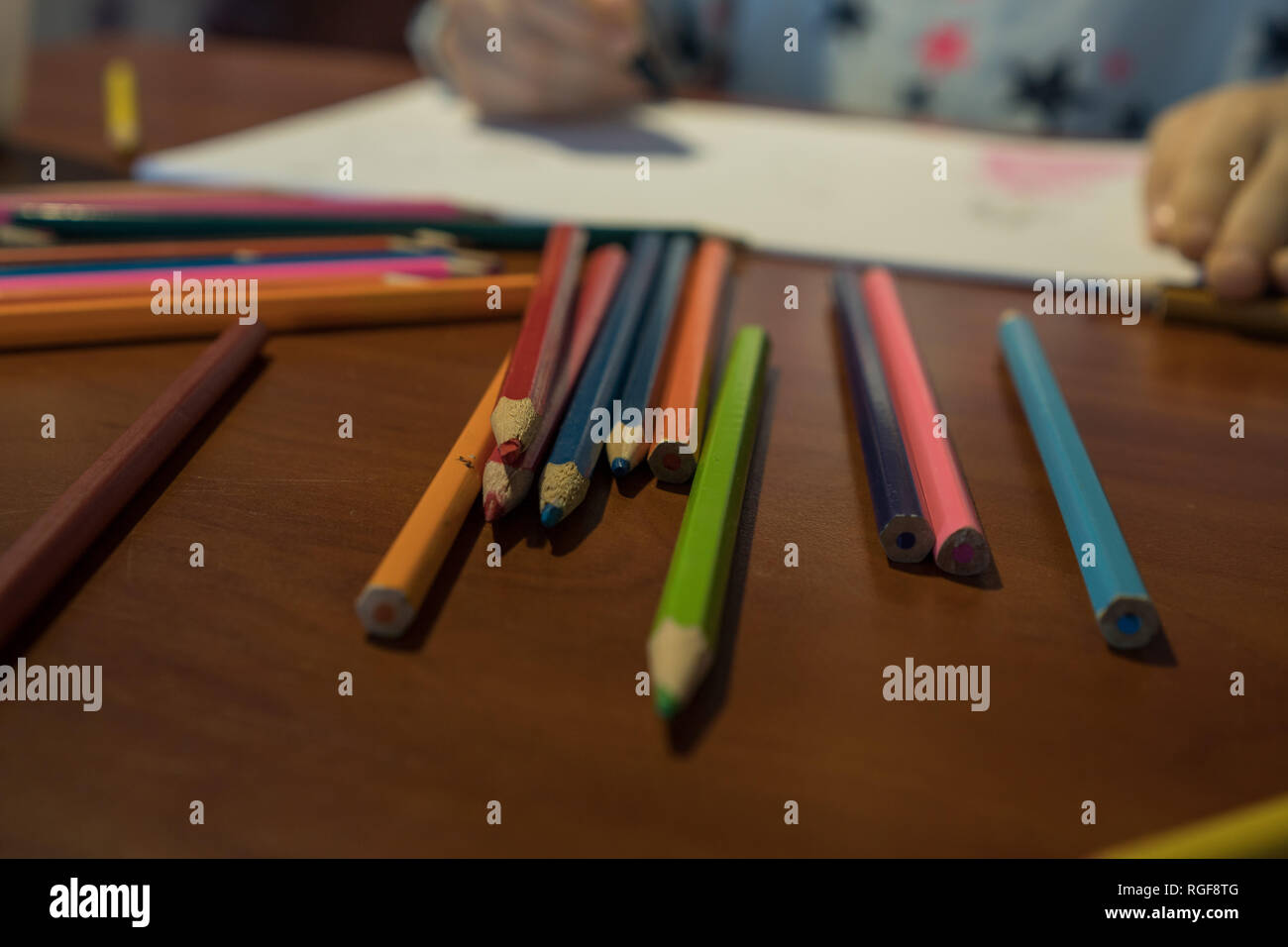Colored Pencils And A Sketch Pad On A Wooden Table Stock