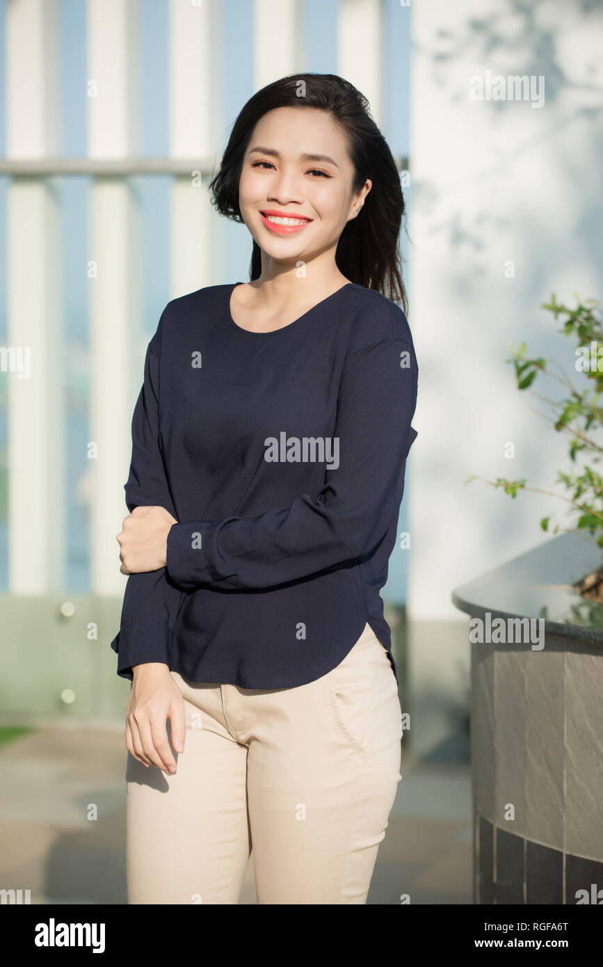 Beautiful girl at summer terrace in garden on a sunny day.  Happy joyous smiling lady. Stock Photo