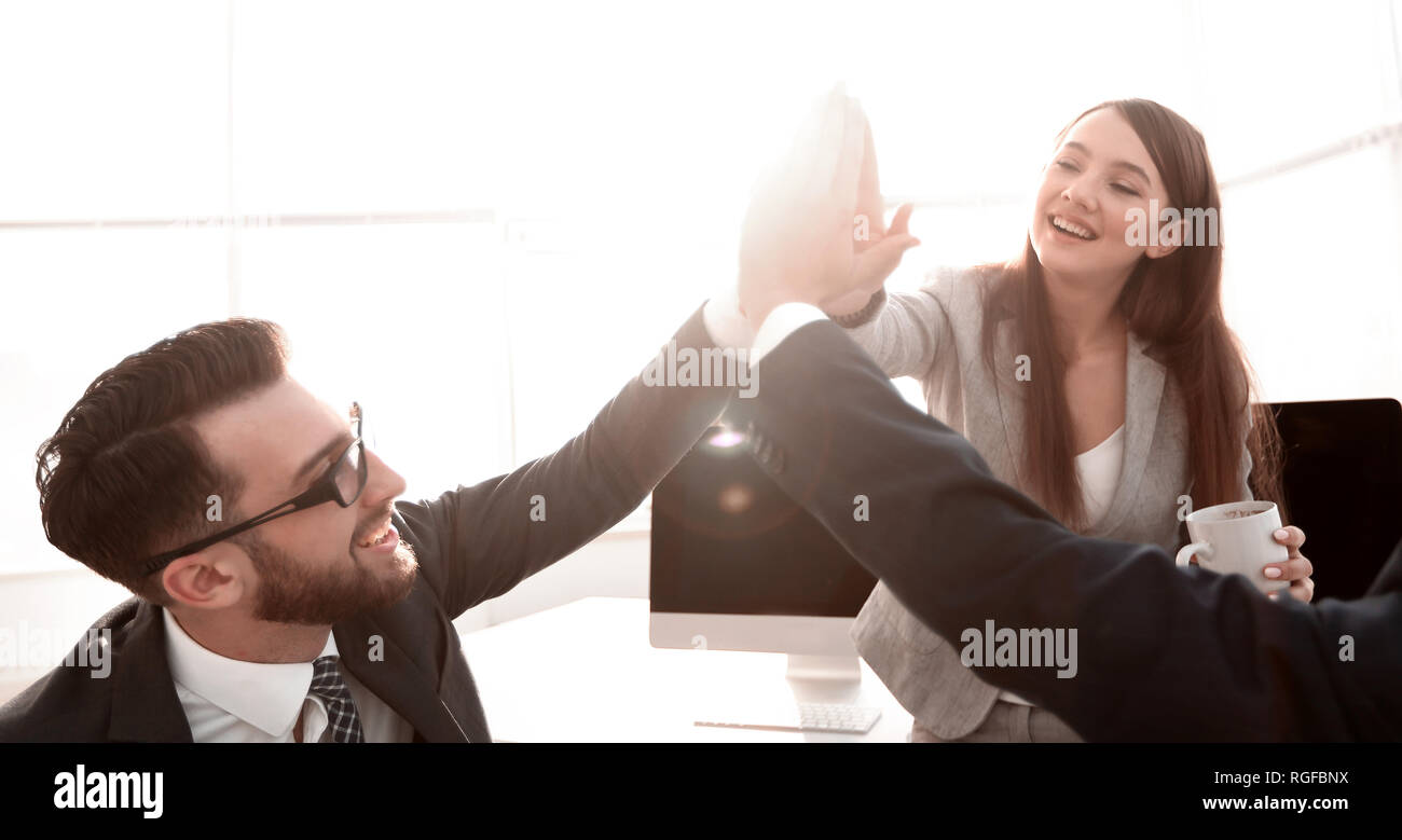 business team giving each other a high five Stock Photo - Alamy