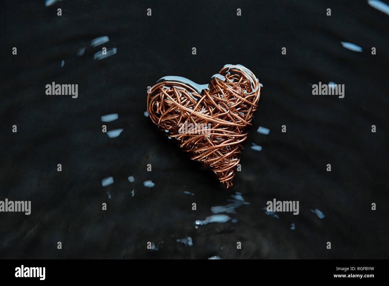 Copper wire heart made from reclaimed electric cable. Highlights on