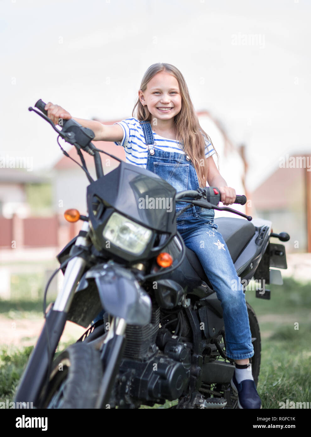 Little girl top riding motorcycle