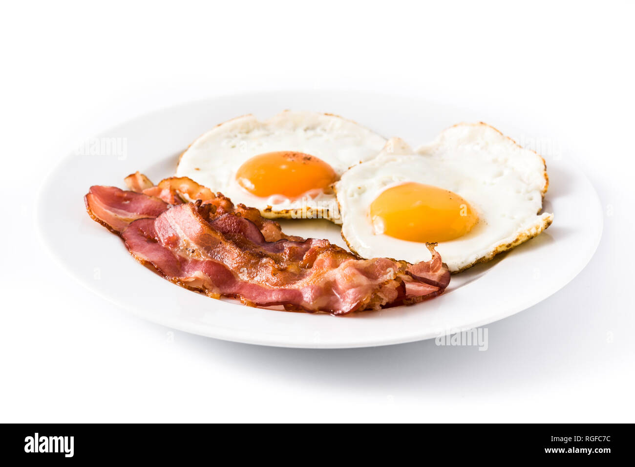 Fried eggs and bacon for breakfast isolated on white background. Stock Photo
