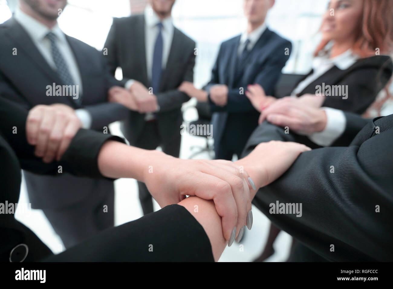 closeup. business team showing their unity Stock Photo - Alamy