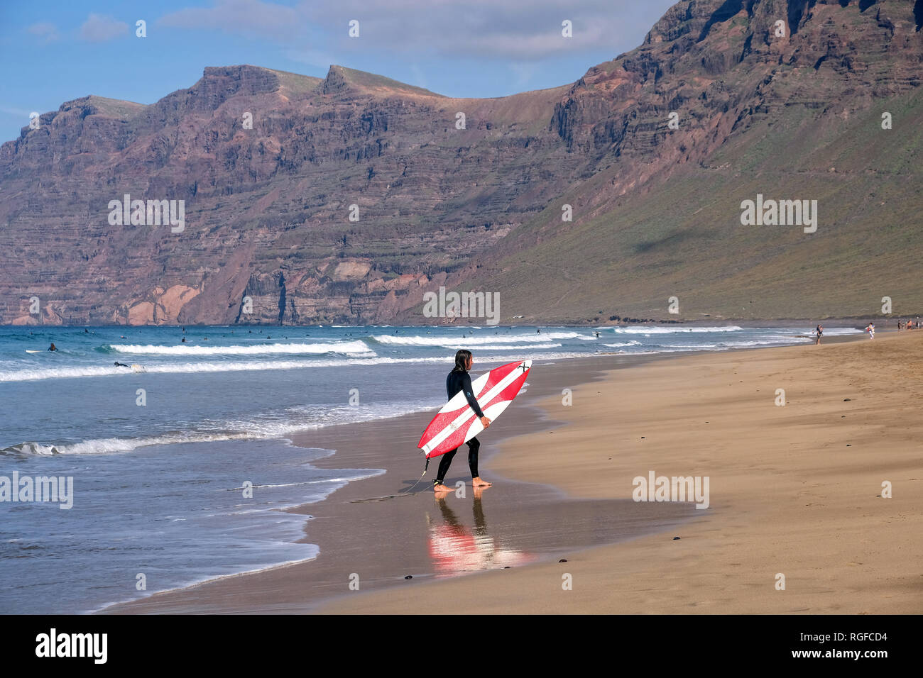 Surfer at Playa de Famara. Stock Photo