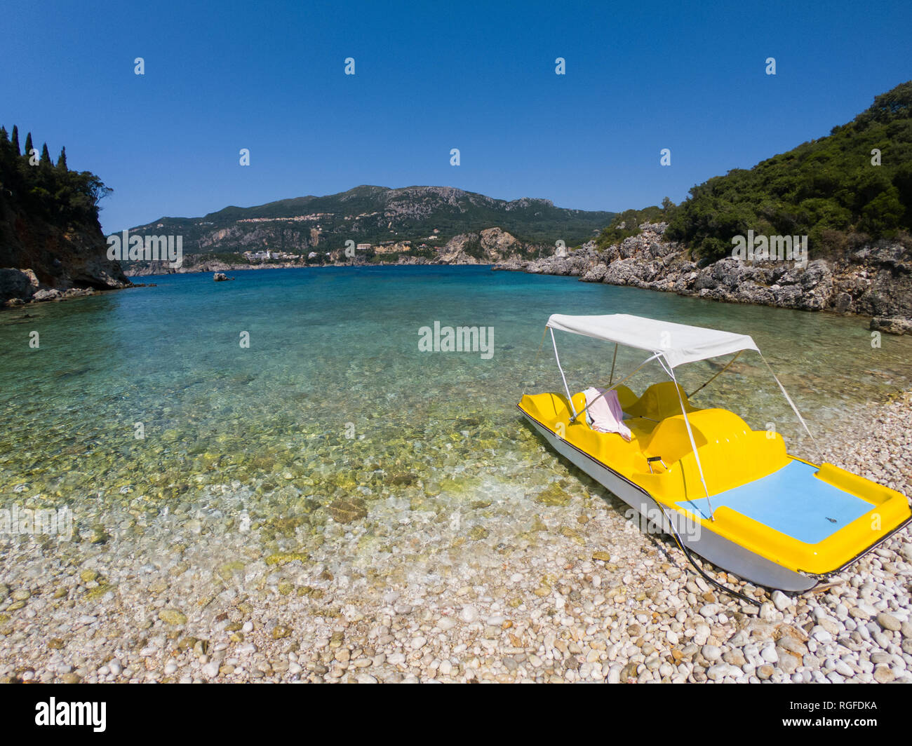 Yellow paddle boat on the beach. Rovinia beach, Paleokastrista, Corfu Stock Photo