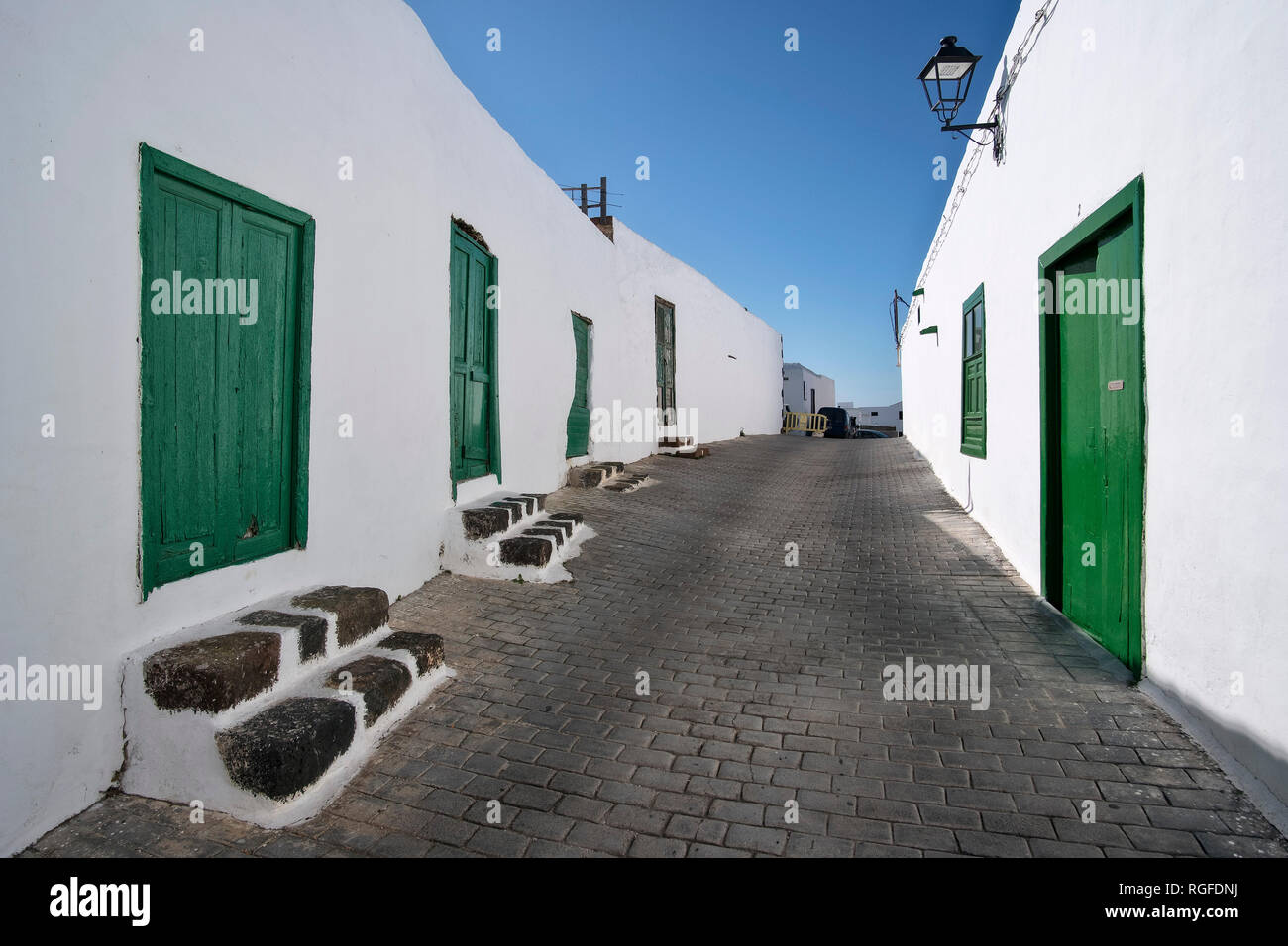 Alley with green doors in Teguise. Stock Photo