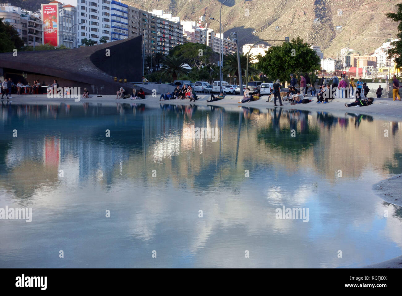 People enjoy the last of the afternoon sun beside El Lago de Plaza Espana in Santa Cruz de Tenerife, Canary Island, Spain Stock Photo