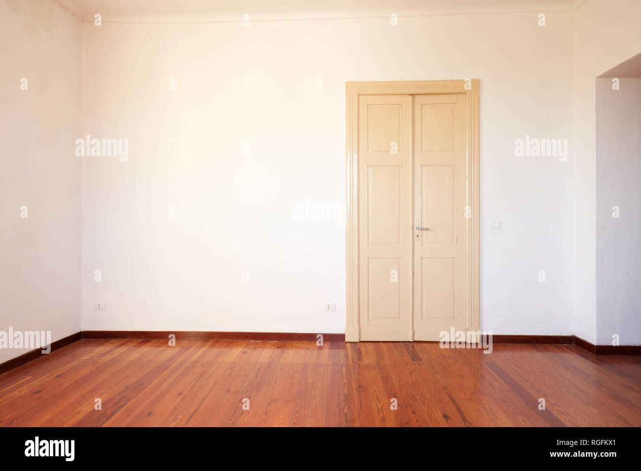 Empty room with wooden floor and door in old house Stock Photo