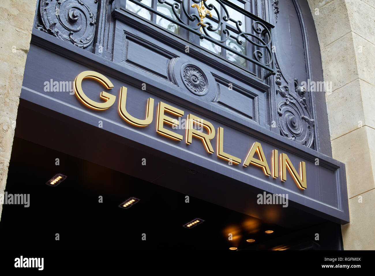 PARIS, FRANCE - JULY 07, 2018: Guerlain store with golden letters sign in Paris and ancient building facade Stock Photo
