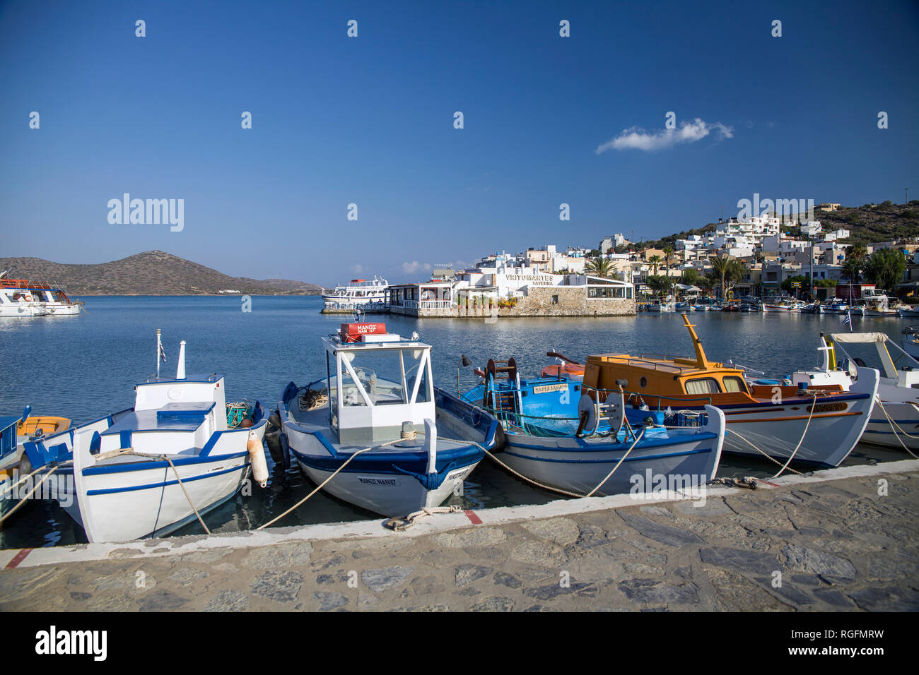 Small colorful fishing boats in the port. The harbor of Elunda in Crete, Greece. Stock Photo