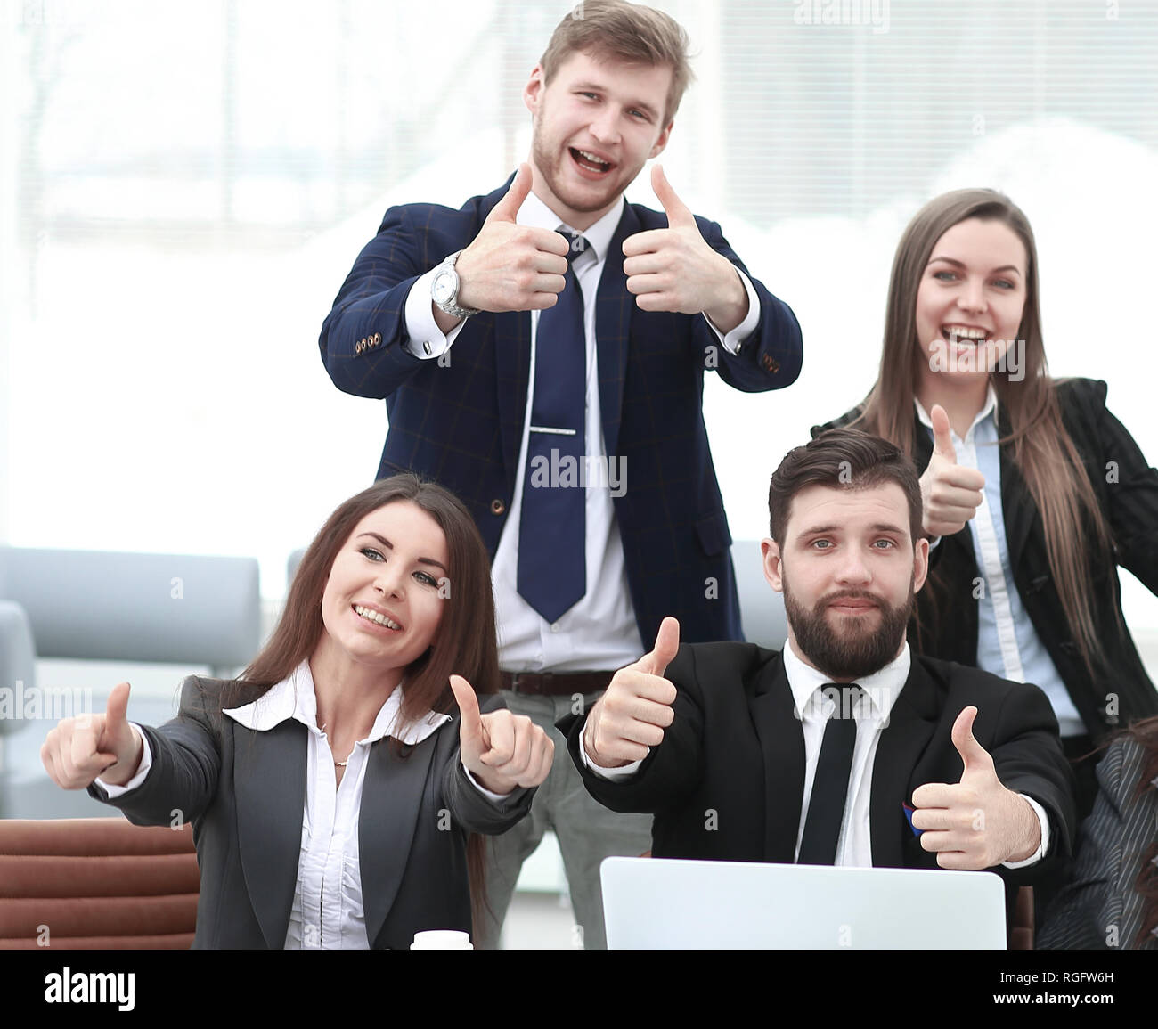 happy professional business team showing thumbs up Stock Photo - Alamy