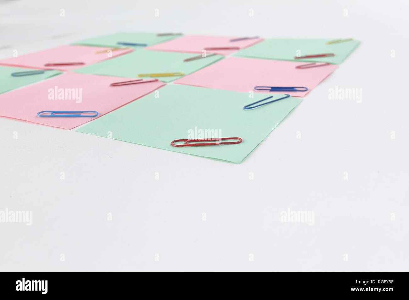 multiple blank sheets for notes with paper clips isolated on white background Stock Photo